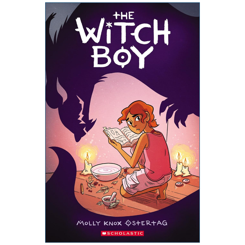 The front cover of the book 'The Witch Boy' by Molly Knox Ostertag, published by Scholastic. The illustration features a boy with red hair reading a book on a table lit by candles, with a large dark wolf silhouette looming behind him against a purple and pink background.