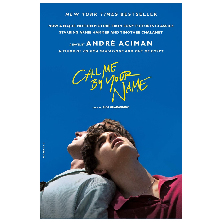 Book cover for the novel 'Call Me By Your Name' by André Aciman, featuring a bright blue background with yellow title text and a photo of two young men looking upward at the bottom.