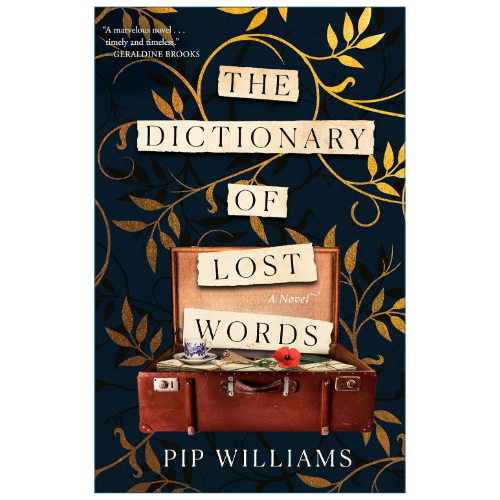 Book cover for 'The Dictionary of Lost Words' by Pip Williams, featuring a dark navy background with gold vine illustrations, cream title lettering, and an open brown suitcase at the bottom containing books and a red flower.